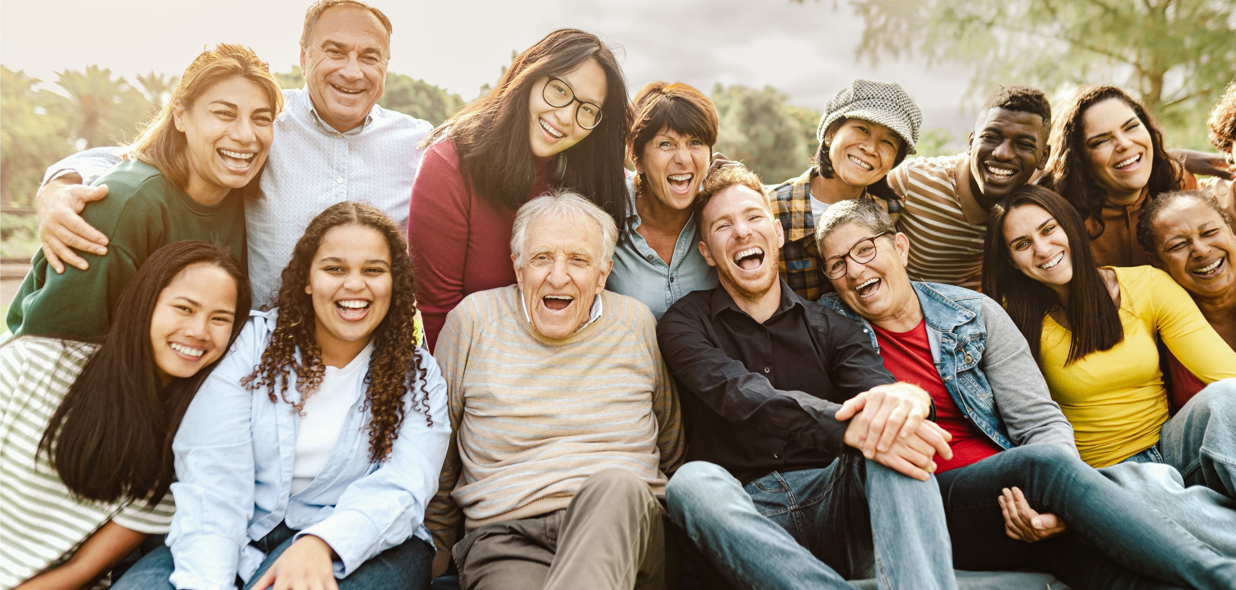 A big group of people all sitting together and laughing