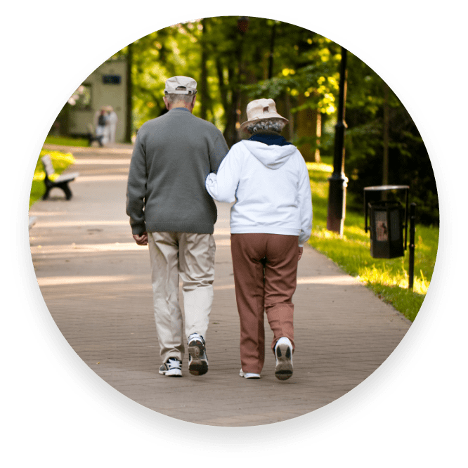 A picture of an elderly couple going for a walk holding hands